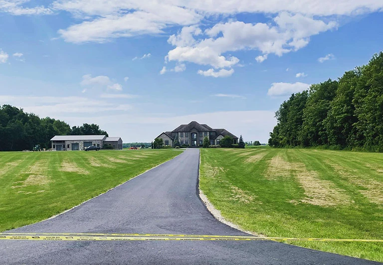 Newly paved long-distance asphalt driveway for a rural estate property in Norfolk County.