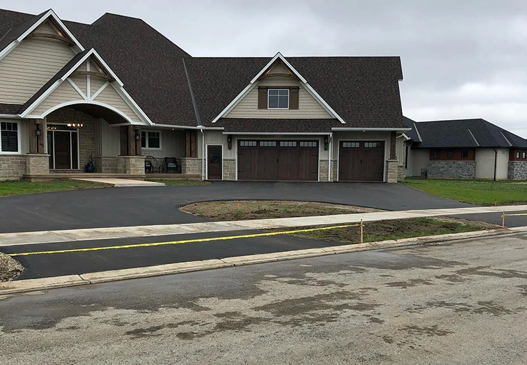 Custom residential asphalt paving for a large circular driveway at a premium estate in Southwestern Ontario.