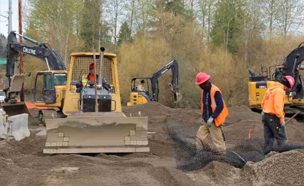 Peters Paving crew using John Deere bulldozers and excavators for large-scale industrial earthmoving and soil stabilization.