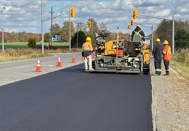 Peters Paving crew and machinery performing public road asphalt paving and infrastructure work in Southwestern Ontario.